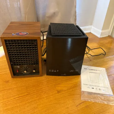 Sale Photo Thumbnail #179: Living Air wood-grain air purifier paired with a modern Vollara Air & Surface Pro air purification system and its user manual.