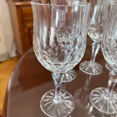 Sale Photo Thumbnail #311: Set of crystal wine goblets featuring a tulip-shaped bowl with diamond-cut detail and starburst bases.