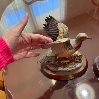 Sale Photo Thumbnail #237: Hand-painted duck figurine in mid-flight mounted on a wooden display base.