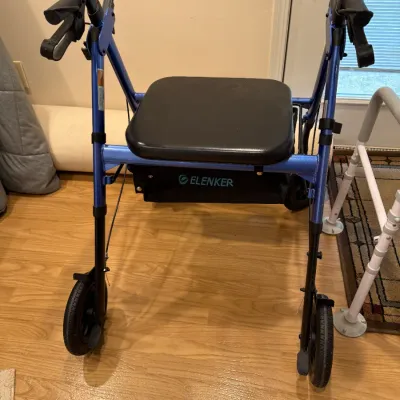 Sale Photo Thumbnail #136: Blue ELENKER rolling walker featuring a padded seat, backrest bar, under-seat storage pouch, and hand brakes.
