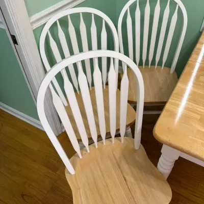 Sale Photo Thumbnail #171: Set of country-style dining chairs featuring white spindle backs and natural light wood seats.