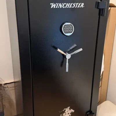 Sale Photo Thumbnail #144: Black Winchester Ranger Deluxe gun safe with an electronic keypad lock and three-spoke chrome handle.
