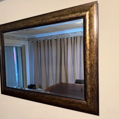 Sale Photo Thumbnail #66: Large wall mirror with a wide, mottled bronze and gold-finished frame.