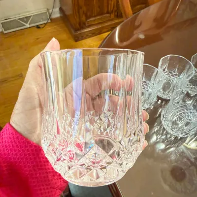 Sale Photo Thumbnail #308: Vintage cut crystal double old fashioned glass featuring diamond and vertical panel cuts, shown with additional matching glassware.