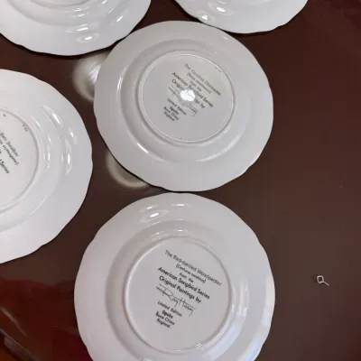 Sale Photo Thumbnail #219: Set of Spode bone china collector plates from the American Songbird Series by Ray Harm, featuring printed maker's marks on the underside.