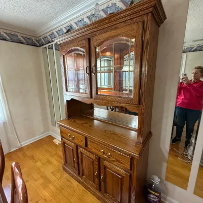 Sale Photo Thumbnail #190: Traditional golden oak hutch featuring leaded glass upper cabinet doors, brass hardware, and lower storage drawers and cabinets.