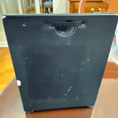 Sale Photo Thumbnail #193: Back side of a black wall-mounting object or photo frame featuring a sawtooth hanger and minor edge wear.