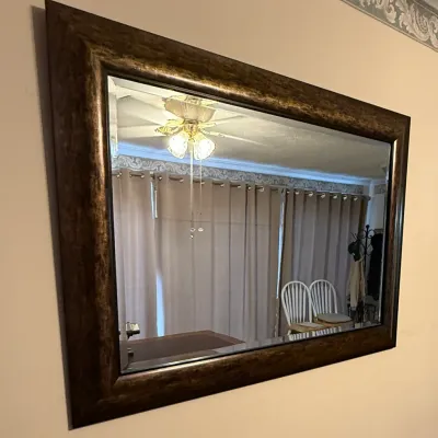 Sale Photo Thumbnail #63: Large rectangular wall mirror featuring a beveled glass edge and a thick, mottled bronze-finish frame.