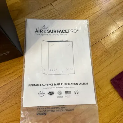 Sale Photo Thumbnail #182: Instruction manual for a Vollara Air & Surface Pro+ portable surface and air purification system, sealed in a clear plastic bag.