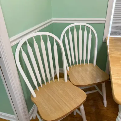 Sale Photo Thumbnail #168: Pair of two-tone Windsor style dining chairs featuring natural oak wood seats and white painted spindle backs and legs.