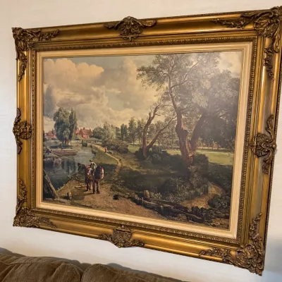 Sale Photo Thumbnail #85: Large framed landscape art print featuring a rural scene with horses and a river, housed in an ornate gilded frame.