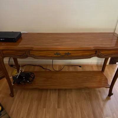 Sale Photo Thumbnail #196: French Provincial style wooden console table with cabriole legs, a single center drawer, and a lower display shelf.