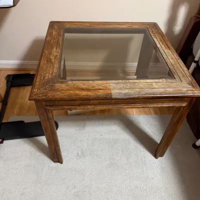 Sale Photo Thumbnail #376: Square wooden side table featuring a inset glass top and light surface wear to the finish.