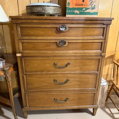 Sale Photo Thumbnail #381: Mid-century wooden tall chest of drawers featuring five drawers with antique-style metal hardware and molded panel fronts.