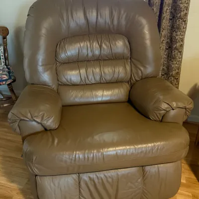 Sale Photo Thumbnail #86: Oversized taupe leather reclining armchair with plush pillow-top arms and Tufted back support.