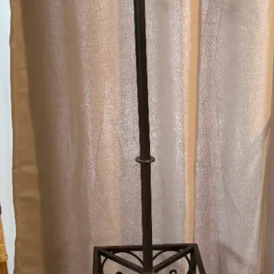 Sale Photo Thumbnail #74: Black wrought iron coat rack and umbrella stand featuring scrollwork detailing, multiple hanging hooks, and a square base.
