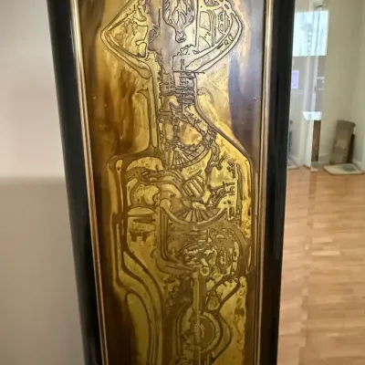 Sale Photo Thumbnail #103: Mid-century modern etched brass panel featuring abstract geometric motifs, encased in a black lacquered frame.
