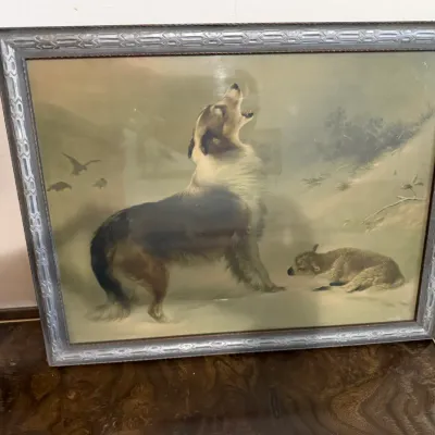 Sale Photo Thumbnail #358: Antique framed print depicting a collie dog howling beside a lamb in a winter landscape, housed in a molded grey frame.