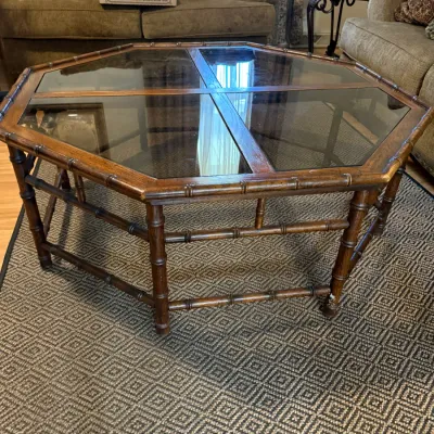 Sale Photo Thumbnail #317: Octagonal faux bamboo wooden coffee table with smoked glass panel inserts.