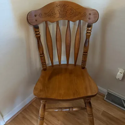Sale Photo Thumbnail #271: Traditional wooden dining chair with a carved crest back and spindle support design.