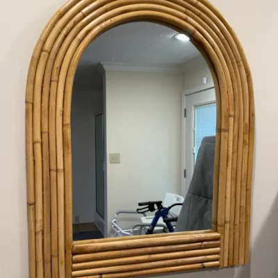 Sale Photo Thumbnail #139: Vintage arched wall mirror featuring a multi-strand bamboo or rattan frame in a boho chic style.