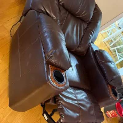 Sale Photo Thumbnail #72: Contemporary dark brown faux leather power reclining armchair, featuring built-in cup holders with wood-grain trim in both armrests.