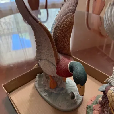 Sale Photo Thumbnail #243: Hand-painted porcelain mallard duck figurine featuring outstretched wings and detailed feather textures.