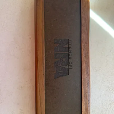 Sale Photo Thumbnail #186: Rectangular wooden presentation box or case featuring an embossed 'Friends of NRA' logo on the dark inset lid.