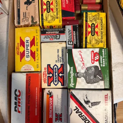 Sale Photo Thumbnail #265: Cardboard box filled with various vintage ammunition boxes, including Winchester Super-X, Federal, Remington, and PMC brands.