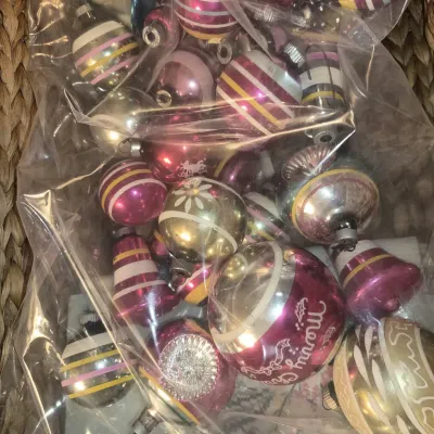 Collection of vintage glass Christmas ornaments packaged in a clear plastic bag, featuring striped, painted, and bell-shaped designs in...