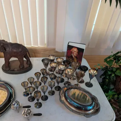 Collection of vintage silver-plated items including a large set of goblets, covered serving dish, trays, and smoking accessories,...