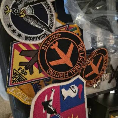 Collection of vintage military embroidered flight patches, including 555th Fighter Squadron, F-100 Vietnam, and 4521st CCTS 'The...