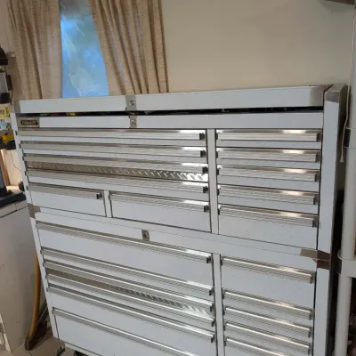 Large Steel Glide stainless steel rolling tool chest combo with diamond-plate drawer accents and locking casters.