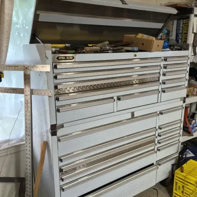Steel Glide rolling tool chest and cabinet combo in stainless steel finish with diamond plate accents and multiple drawers.