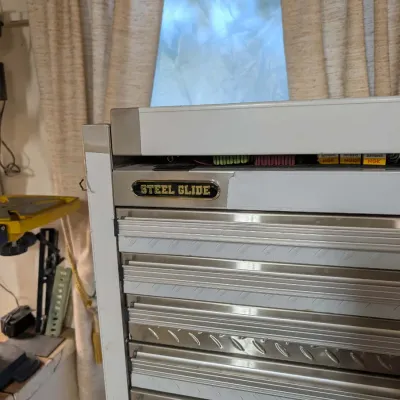 Steel Glide stainless steel rolling tool chest featuring multiple diamond-plate detailed drawers.