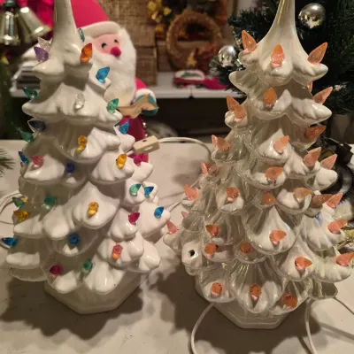 Pair of vintage white ceramic illuminated Christmas trees, including one with multicolored plastic pegs and one with iridescent finish...