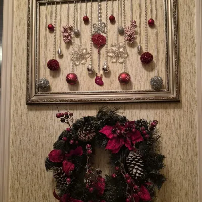 Framed Christmas ornament wall display featuring red and silver baubles paired with a matching artificial pine wreath accented with...