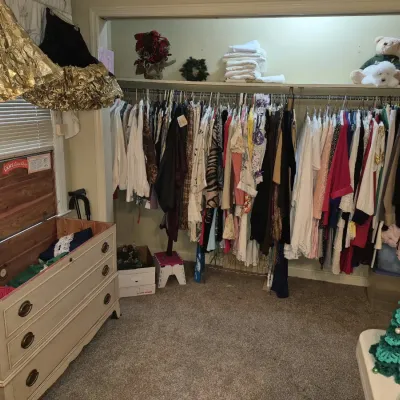Closet full of vintage women's clothing alongside a Lane cedar chest disguised as a dresser.