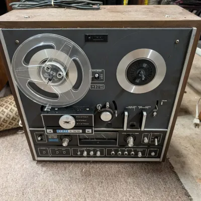 Akai X-1810 reel-to-reel tape recorder and 8-track player combo in a wood cabinet, circa 1970s.