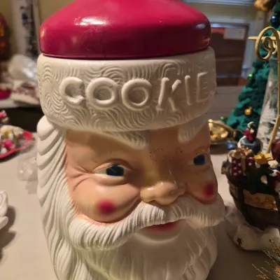 Vintage Santa Claus head cookie jar featuring relief 'COOKIE' lettering along the hat trim.