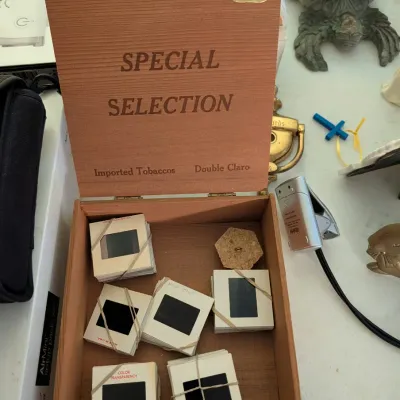 Vintage National Cigar Co. wooden cigar box filled with bundled 35mm film slides.