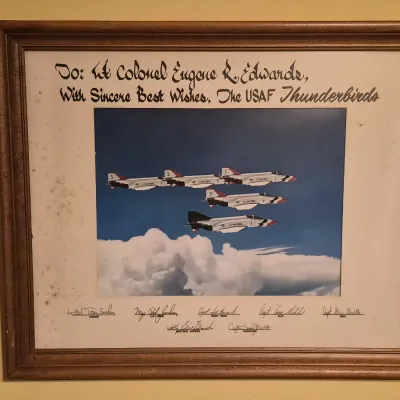 Framed autographed photo of the USAF Thunderbirds flying F-4 Phantom II jets, dedicated to Lt. Colonel Eugene R. Edwards.