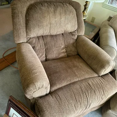 Sale Photo Thumbnail #640: Brown textured fabric recliner armchair featuring padded armrests and a plush headrest pillow.