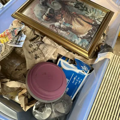 Sale Photo Thumbnail #563: Framed vintage-style Santa Claus print sitting atop newspaper packing and household items in a storage tote.