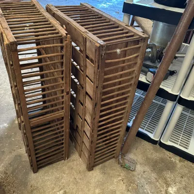 Sale Photo Thumbnail #527: Pair of vintage rustic wooden slatted crates or poultry coops, featuring aged timber construction with natural patina.