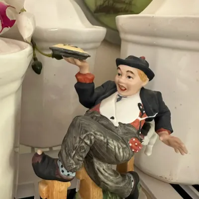 Sale Photo Thumbnail #658: Vintage Norman Rockwell collectible porcelain figurine featuring a boy balancing a pie, displayed on a wooden base.