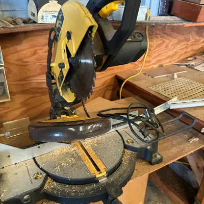 Sale Photo Thumbnail #510: DeWalt compound miter saw showing light dust and wear from workshop use.