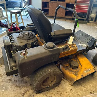 Sale Photo Thumbnail #521: Cub Cadet Z-Force zero-turn riding lawn mower powered by a Kohler engine, showing visible wear, dirt, and a flat rear tire.