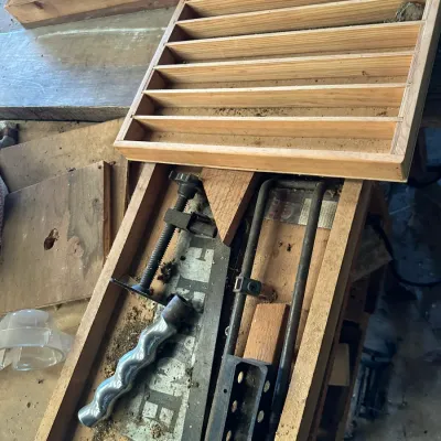 Sale Photo Thumbnail #514: Collection of wooden workshop items, including a multi-slot drawer organizer tray, scrap lumber, and miscellaneous metal tool parts.