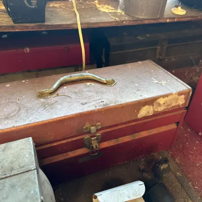 Sale Photo Thumbnail #484: Vintage My Buddy metal tackle or tool box with brass-tone latches and top handle, displaying heavy wear and paint loss.
